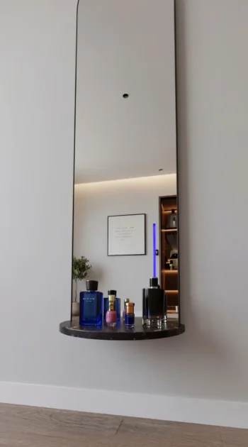 Arched Luxe Wall Mirror with Shelf dark marble floating shelf close-up 1
